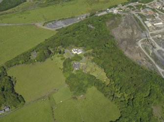 General oblique aerial view of Hillhouse with the Whinstone quarry adjacent, taken from the SSE.