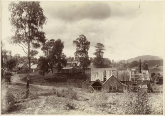 View of mill at Kinrara, near Aviemore, with slightly dilapidated wooden buildings. 
Titled: 'Bobbin Mill /93'.

