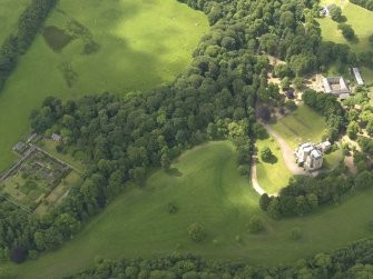 Oblique aerial view of Caprington Castle and policies, taken from the NE.