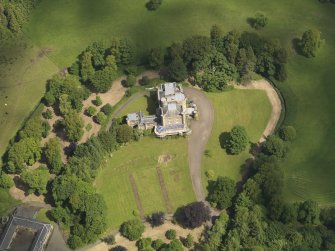 Oblique aerial view of Caprington Castle and stables, taken from the SSW.