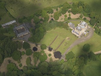 Oblique aerial view of Caprington Castle and stables, taken from the SSE.