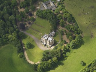 Oblique aerial view of Caprington Castle and stables, taken from the ENE.