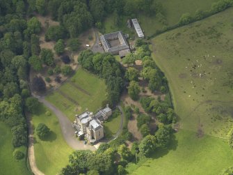 Oblique aerial view of Caprington Castle and stables, taken from the NE.