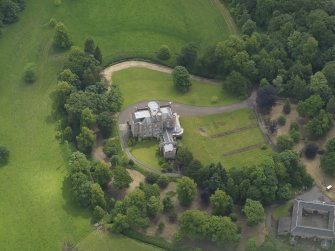 Oblique aerial view of Caprington Castle and stables, taken from the WNW.