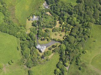 Oblique aerial view of Manor Park Hotel and stables, taken from the WSW.
