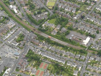 Oblique aerial view centred on the railway station, taken from the NW.