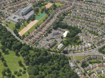 General oblique aerial view centred on the church with the school adjacent, taken from the NE.