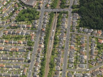 Oblique aerial view centred on the railway station, taken from the W.