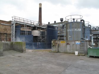 View of Building 5. Effluent Treatment Plant: detail of Sludge Thickener Tank being dismantled and Ferrous Chloride Tank, looking south east.