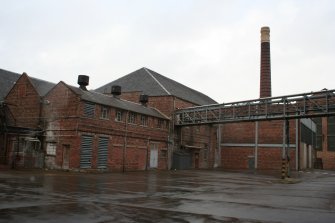 Storage Yard (NO45091 19514) looking northwest with overhead gantry carrying wood pulp from Wood Pulp Storage (Building 1) off to the right of the image, to the Stock Preparation House (Building 2, first floor), centre.