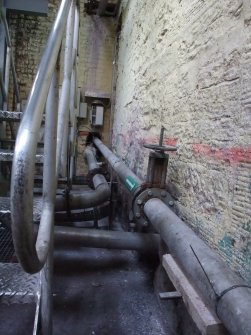 Interior. Building 19, No. 3 Paper Machine House, wet end pipes from pressure screen carrying stock to flowbox (out of shot on left).