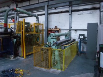 Interior. Building 19, No.3 Paper Machine House. View of Embosser adjacent to Paper Machine No. 3.