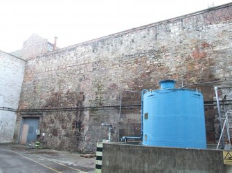 General view. West Yard Central. Rear wall of former Bleach Plant, from SSE showing remnants of distillery building walls.