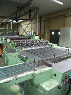 Interior. Building 7, Finishing Department:, adjacent to former Calender House (Building 6). View of multiple reel sheeter handling five reels and cutting to A4.