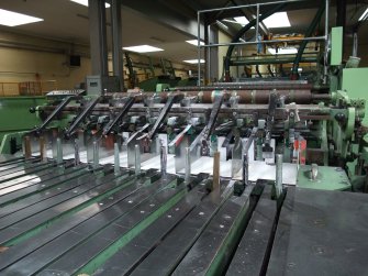 Interior. Building 7, Finishing Department:, adjacent to former Calender House (Building 6). View of finishing Department, Multiple reel sheter cutting to A4 size.