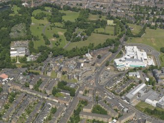 Oblique aerial view centred on the infirmary with the new block adjacent, taken from the SSE.