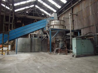 Interior. Building 1,  Wood Pulp Storage Shed (North). View of Pulper No 2 wth conveyor. This pulper supplied Paper Machine No 5.