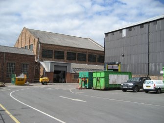 General view looking SW. Building 6, former Calender House, latterly part of Finishing Department to left. This building contained stretch wrap machines, Jagenberg winders etc. Wood Pulp store (Building 1) to right of picture.