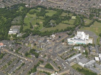 Oblique aerial view centred on the infirmary with the new block adjacent, taken from the SSE.