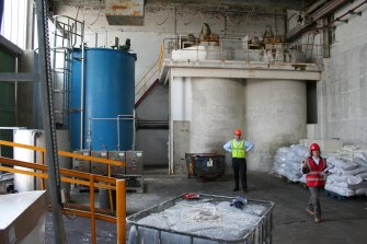 Interior. Clay Mixing House, looking south, showing Gallery Vats (disused on date of visit) on the right behind Charles Whittaker (production manager). The blue tank and the dosing pumps on the left fed additives to the clay mixing Gallery Vats.