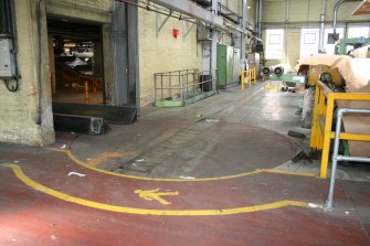 Interior. Building 6, former Calender House, latterly Finishing Department. View showing paper reel handling turntable and conveyor, for moving paper reels from Paper Making Machines (no.5 in left background) to Reel Slitters (right hand side).