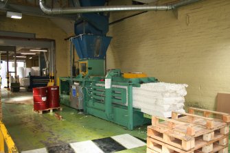 Interior. Building 7, Finishing Department. View of waste baler.