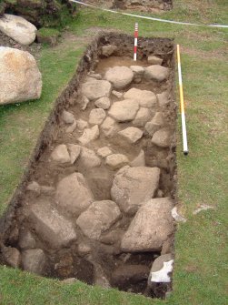 Trench 16 from SSW showing paving F16.01 (Scales = 2m & 0.5m)