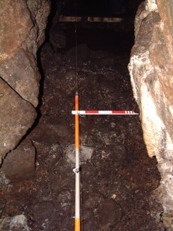 Trench 17 from N, surface of C17.06, within narrow section of Bone Passage (Scales = 2m & 0.5m)