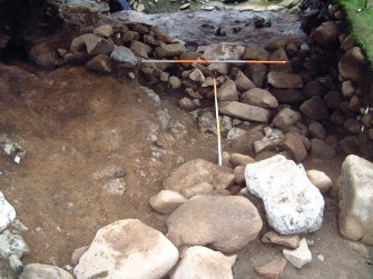 Tremch 15 from the SW showing the rublle infill behind revetment wall F15.14 and revetment F15.08 (scales = 2m)