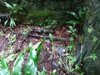 Interior of now roofless pumphouse. Remnants of pump and piping. Water from adjacent well (NT95SW 120.13) taken and pumped up to the main hosue and over pipe bridge to walled garden on N side of the Linn Burn (Nabdean and Paxton Burns merge to become the Linn Burn).