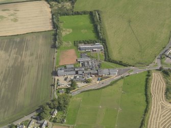 Oblique aerial view centred on the school/community centre with the primary school adjacent, taken from the W