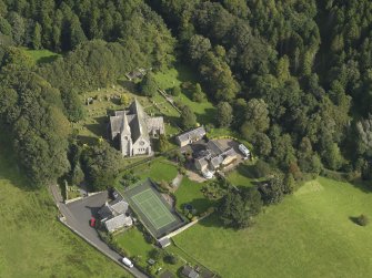 Oblique aerial view centred on the church, taken from the W.