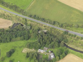 Oblique aerial view centred on the railway bridge, taken from the SW.