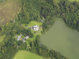 Oblique aerial view centred on the country house with the stable block adjacent, taken from the WSW.