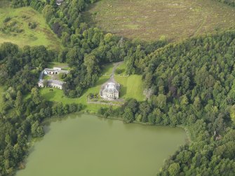 Oblique aerial view centred on the country house with the stable block adjacent, taken from the SSE.
