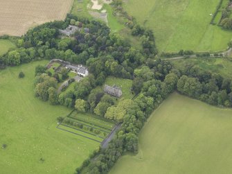 Oblique aerial view centred on the church with the churchyard and manse adjacent, taken from the ESE.