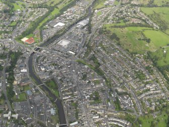 Oblique aerial view centred on the High Street, taken from the SE.