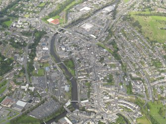 Oblique aerial view centred on the High Street, taken from the SE.