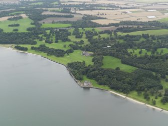 General oblique aerial view centred on the country house with Barnbougle Castle adjacent, taken from the NW.