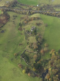 Oblique aerial view centred on the remains of the country house, taken from the E.