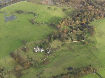 Oblique aerial view centred on the remains of the country house, taken from the SW.