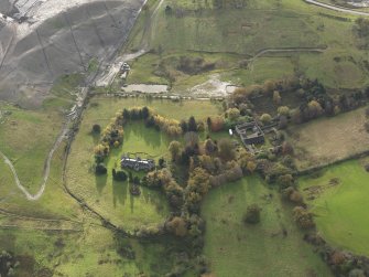 Oblique aerial view centred on the country house, taken from the NNW.