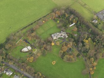 Oblique aerial view centred on castle with the policies adjacent, taken from the  SW.