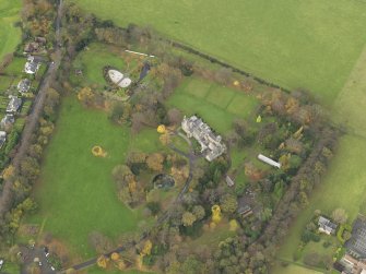 Oblique aerial view centred on castle with the policies adjacent, taken from the  SE.