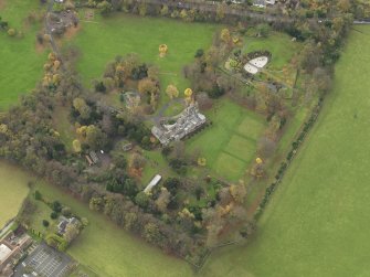 Oblique aerial view centred on castle with the policies adjacent, taken from the NE.