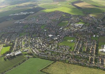 General oblique aerial view centred on town, taken from the E.