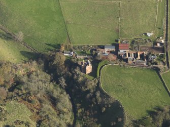 Oblique aerial view centred on the tower house with the farmstead adjacent, taken from the W.