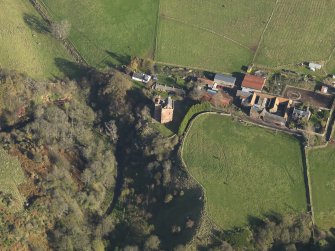 Oblique aerial view centred on the tower house with the farmstead adjacent, taken from the SW.
