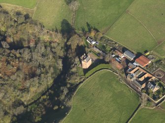 Oblique aerial view centred on the tower house with the farmstead adjacent, taken from the SSW.
