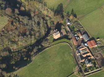 Oblique aerial view centred on the tower house with the farmstead adjacent, taken from the S.
